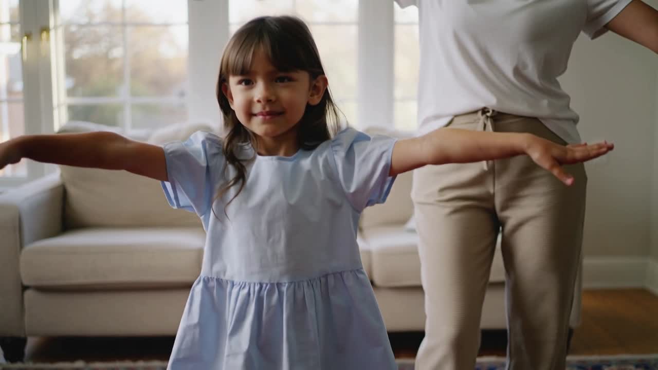 Following parent cue, child holding arms out, stepping on rug before glass doors, playing airplane