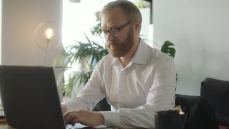 businessman typing on laptop at office workplace