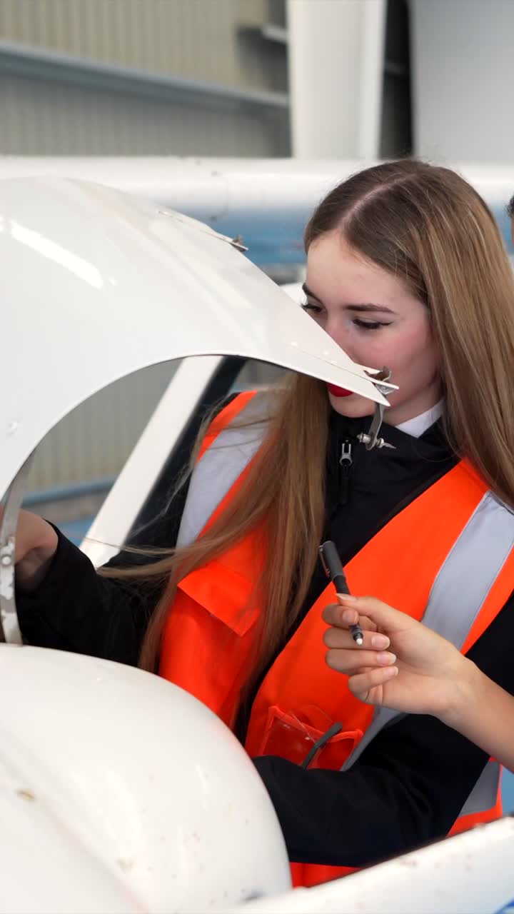 Airplane mechanics inspecting aircraft