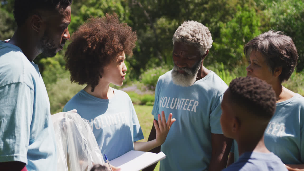 Happy family cleaning a garden together