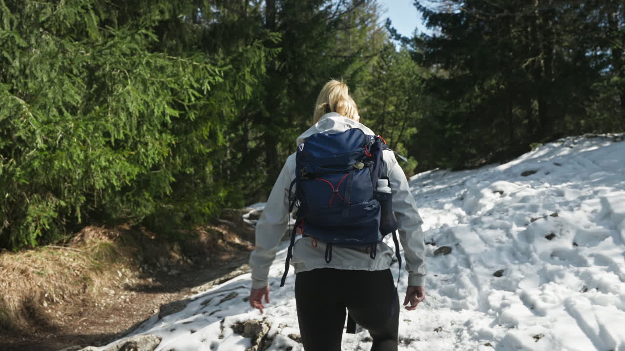 Backpacker On The Trails Covered With Snow In Tatras Mountain In Europe. Slow Motion Shot
