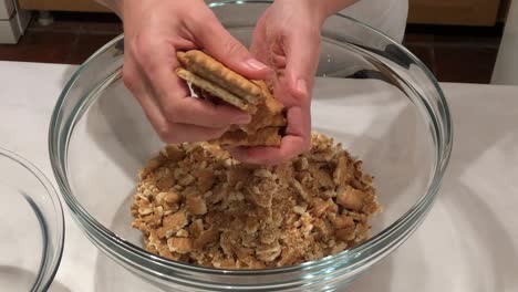 woman preparing biscuit cake in glass bowl