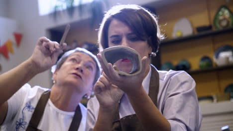 women learning pottery