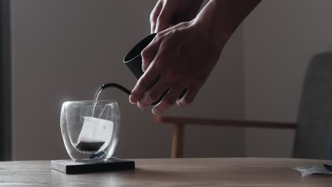 a peaceful moment of making hot tea in soft morning lighting, capturing steam rising gently and a warm, comforting atmosphere. ideal for lifestyle, food, relaxation, or mindfulness content.