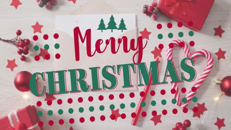 animation of merry christmas text with tree icons and dots over gift box, baubles, sticks and stars