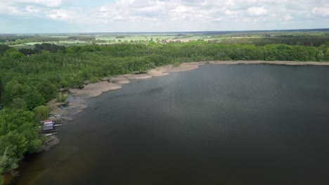 Aerial-footage-of-a-tranquil-lake-surrounded-by-lush-green-forest