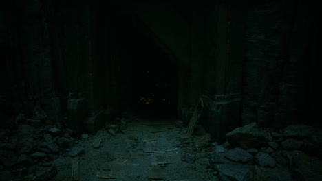 Exploring a dark passageway surrounded by ancient stone and debris