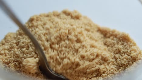 Spoon-pick-brown-sugar-from-a-container-,