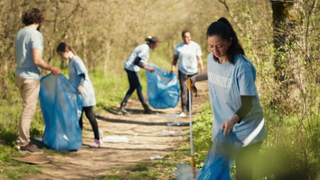 environmental activist picking up trash with a claw tool and recycling