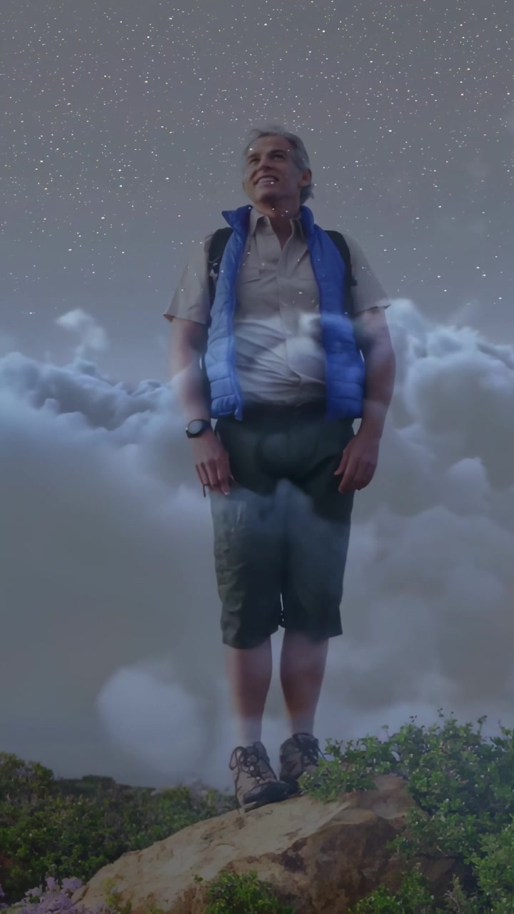Hiker stepping forward on rock, raising arms to embrace starry travel view with cloud overlay