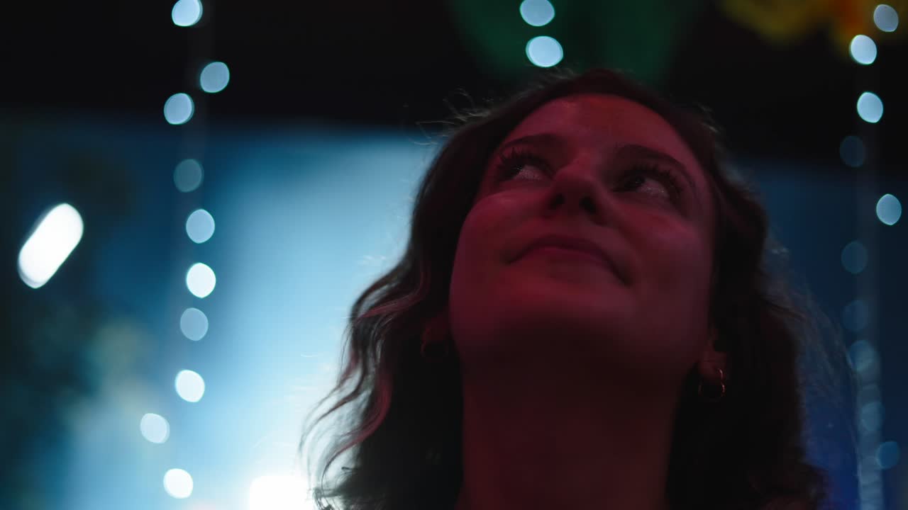 Woman Looking Up at Night Party
