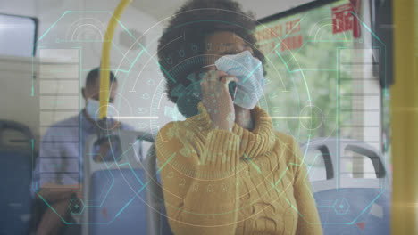 animation of data processing over african american woman with face mask using smartphone