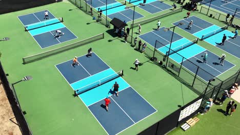 Pickleball-tournament-at-a-multi-court-venue---aerial-view