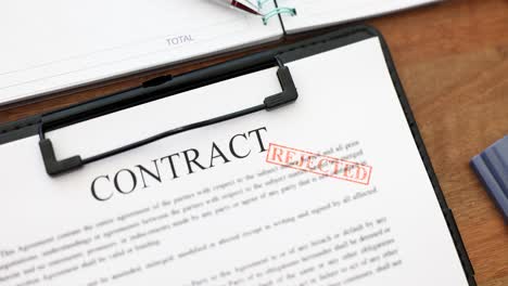 rejected contract document on desk