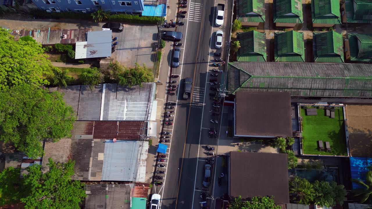 Scenic aerial view of Koh Chang's beachfront and lush green hills. Stunning aerial view flight tilt up drone