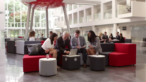 Businesspeople-Meeting-In-Lobby-Of-Modern-Office-Shot-On-R3D