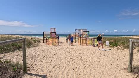 people exploring colorful cube art installation