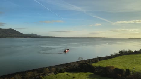 shrimp boat trawler harvesting shrimp on carlingford lough fjord in louth, ireland