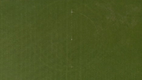 dolly out of top down view of green football field background