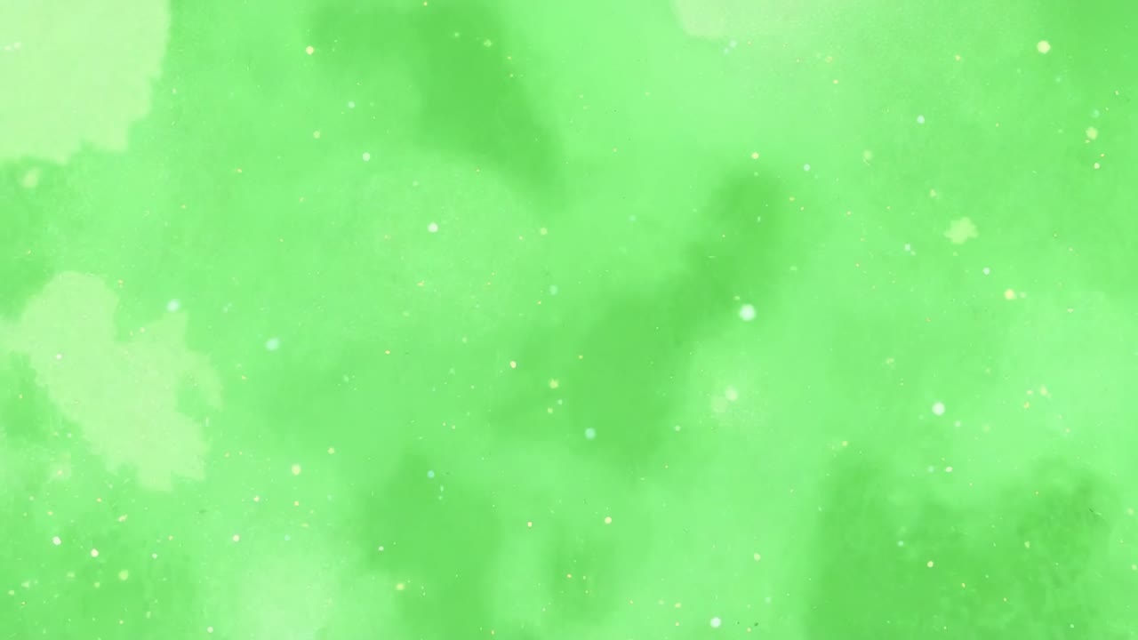 Wiedergabe startet, grüne Wolke treibt und verschiebt sich im Bild, mit leuchtenden Sprenkeln und Lichtblüten.