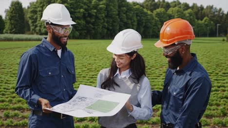 team of engineers reviewing farmland development plans