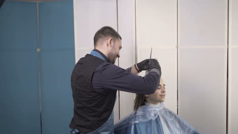 professional hair care. woman cutting her hair in hairdresser salon