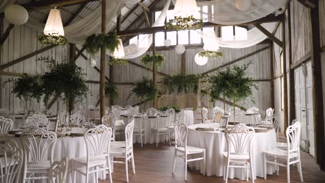 boho wedding wooden venue with stunning lighters and plants