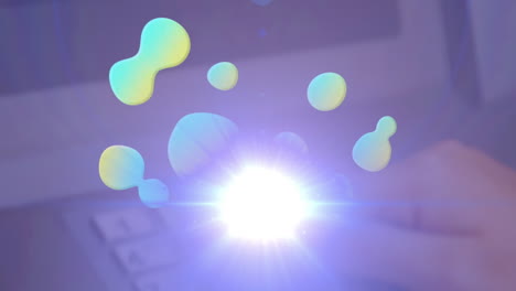 animation of green and yellow blobs and moving spotlight over hand using numeric keypad