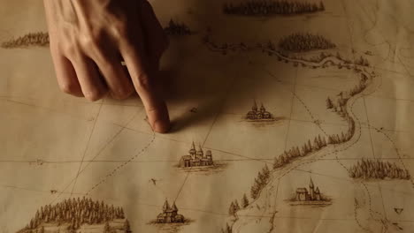 hand pointing on an old fantasy map