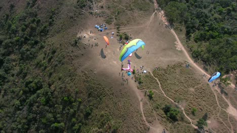 paragliding over hong kong mountains on a beautiful clear day, aerial footage