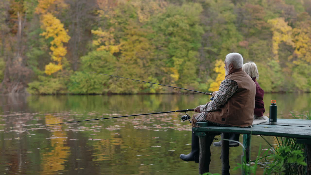 Senior Couple Fishing on a Lake in Autumn