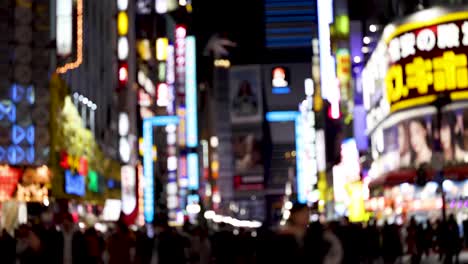 colorful neon signs illuminate busy urban street