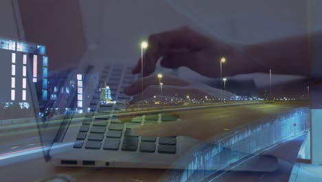 Animation-of-hands-of-woman-using-laptop-over-sped-up-traffic-in-city-at-night