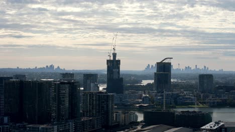 Urban-Evolution:-Modern-Skyscrapers-Adorning-the-Riverside-with-a-Glimpse-of-the-Distant-Urban-Silhouette