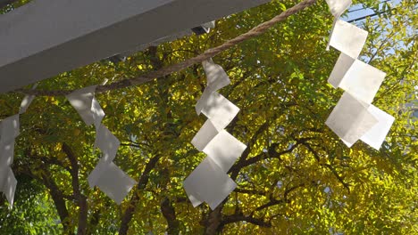 a close-up of white paper streamers (shide), essential elements in japanese shinto rituals, symbolizing purity and the sacred space.