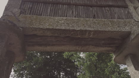 Ground-Up-shot-of-a-granary-alled-espigueiro-over-the-street-in-a-rural-village-on-a-hill-Friaes-Tras-os-Montes-Portugal