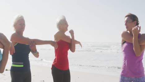 senior women stretching in the beach