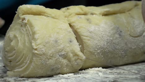 Bread-dough-is-slowly-cut-with-a-thread
