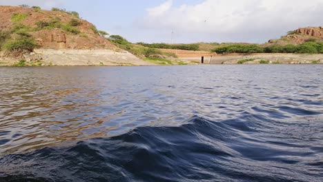 pristine lake view the water wave created by running boat at day