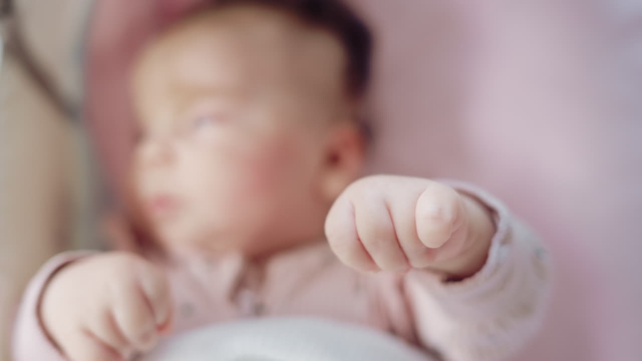Baby reaching out with tiny fingers in dreamy soft focus