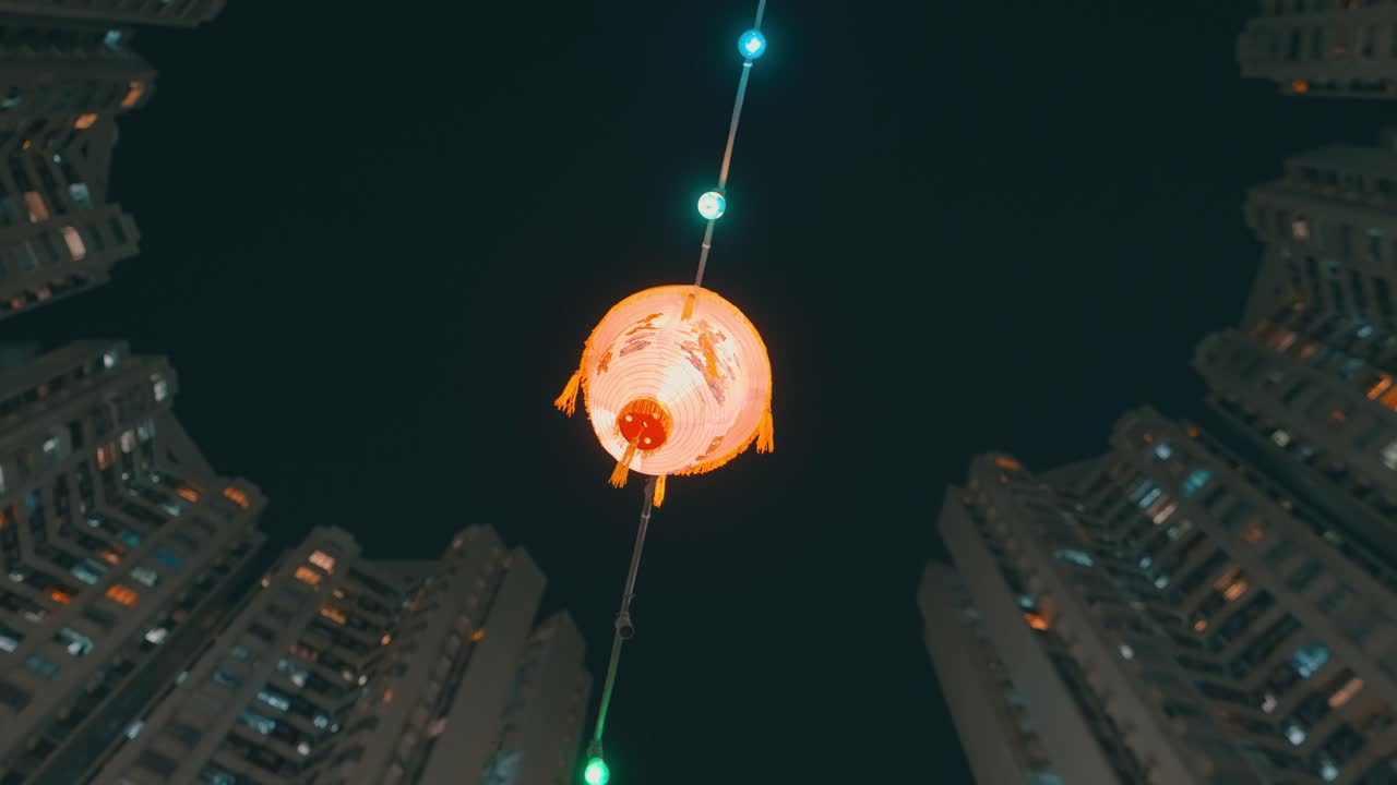 Chinese Lantern Hanging Between City Buildings at Night