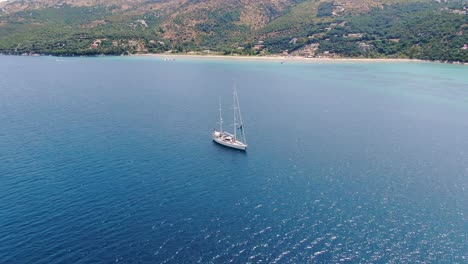 Aerial-drone-view-of-beautiful-boat-in-apraos-beach-in-summer-corfu-greece