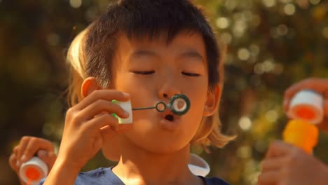 schoolkids playing with bubble wand