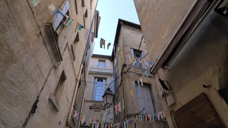 narrow street in montpellier underneath view on lanterns and little flags france