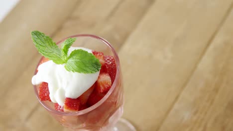 close-up of fresh strawberries with cream in bowl