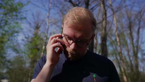 man having a disappointing business call on mobile phone, close up