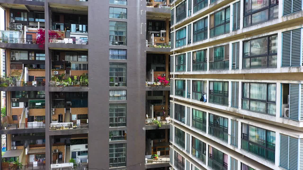 Aerial: Manhattan nature giant dollhouse apartment building during the day in Chengdu, province of Sichuan, orbit drone shot