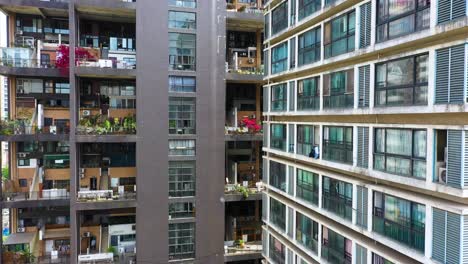aerial: manhattan nature giant dollhouse apartment building during the day in chengdu, province of sichuan, orbit drone shot