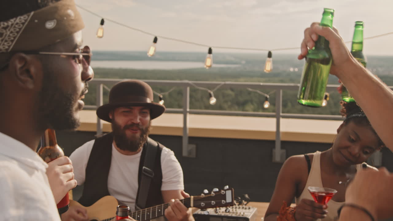 Friends Toasting and Enjoying Music on Rooftop Terrace