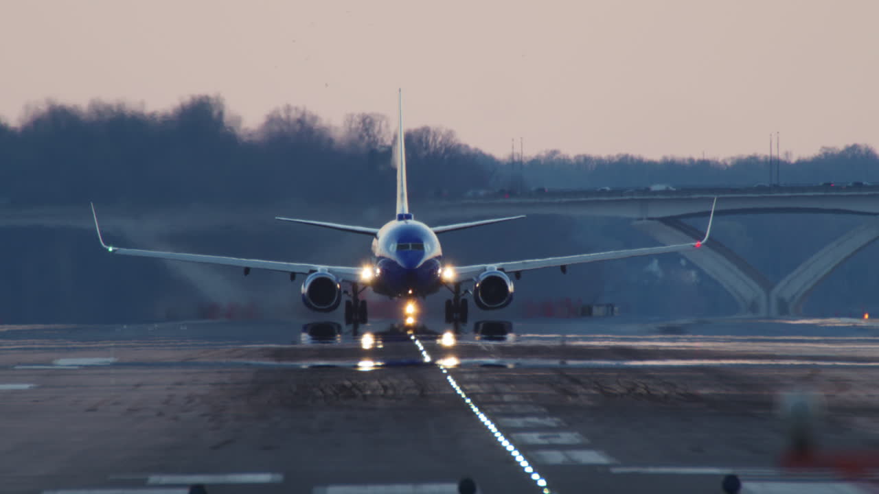 Blue Plane Takes off at Sunset with Camera Tilting to Follow